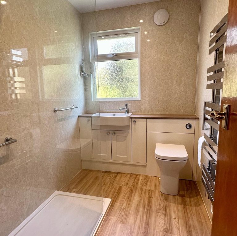 Modern bathroom featuring a stylish walk-in shower, elegant wall and contemporary fixtures.