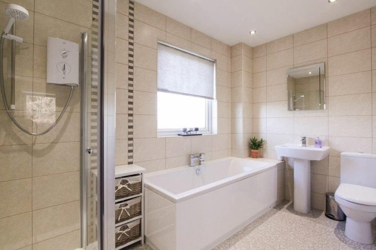 Modern family bathroom featuring a separate shower, spacious bath, contemporary wall tiles and quality bathroom fittings.