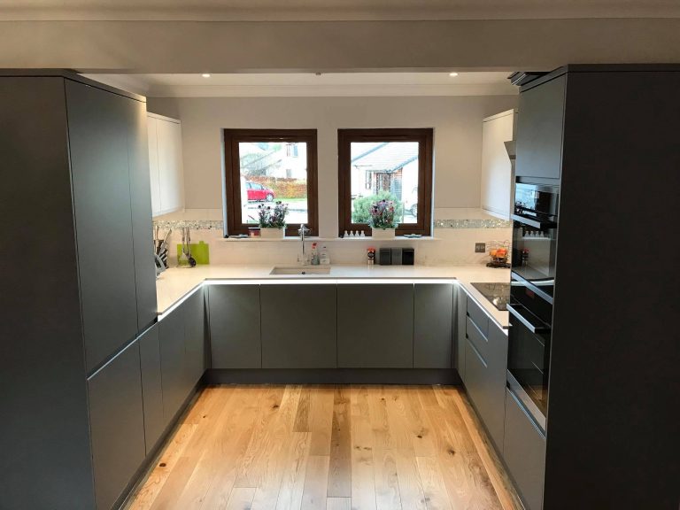 Contemporary kitchen installation by Argyll Bathrooms with modern cabinets, stone worktops, and integrated appliances.