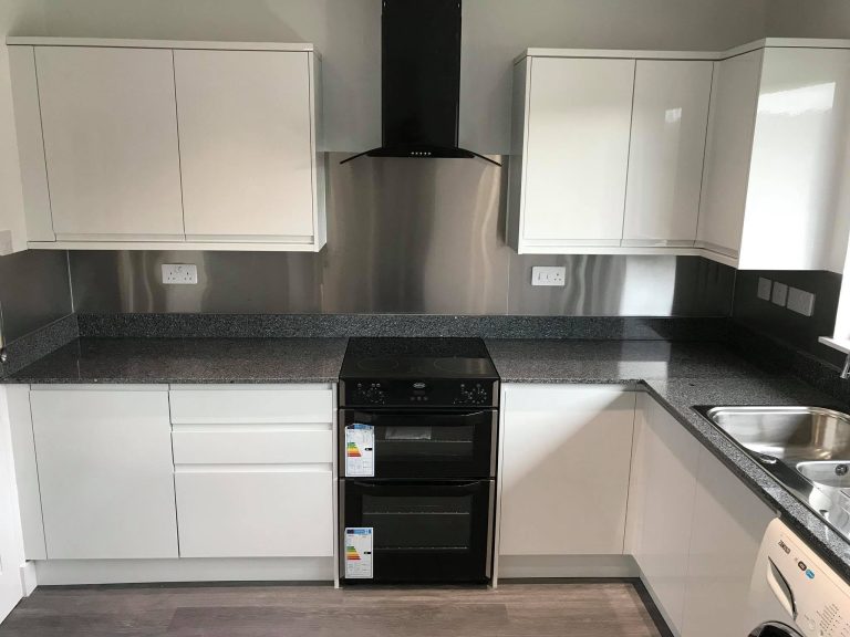 Modern kitchen with cabinets, quality worktops and integrated appliances.
